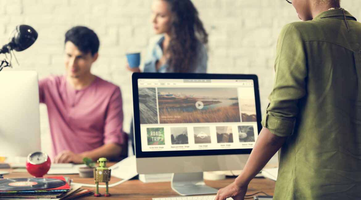 Team implementing essential features onto their website on a mac computer.