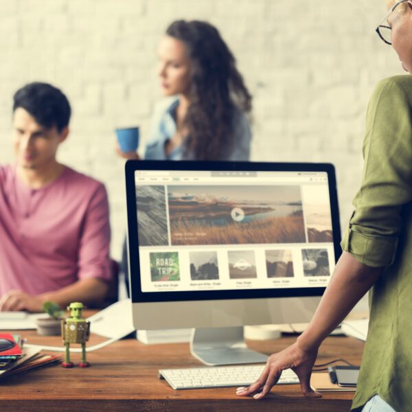 Team implementing essential features onto their website on a mac computer.